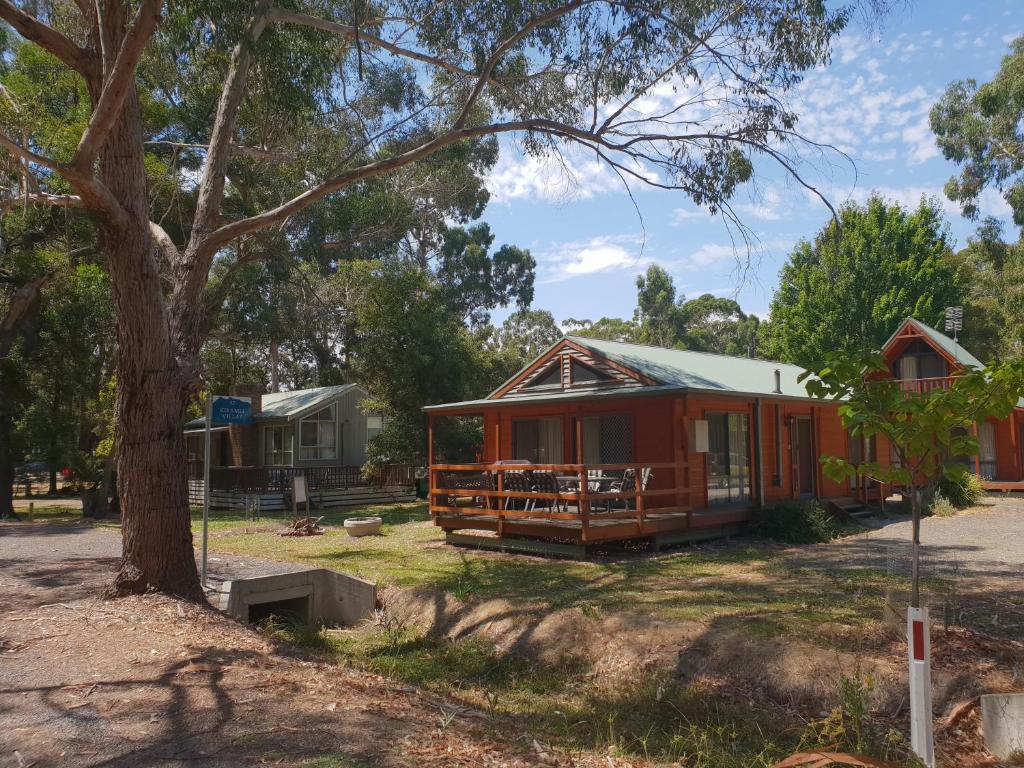 a cabin in a park with a tree at Kiramli Villas in Halls Gap