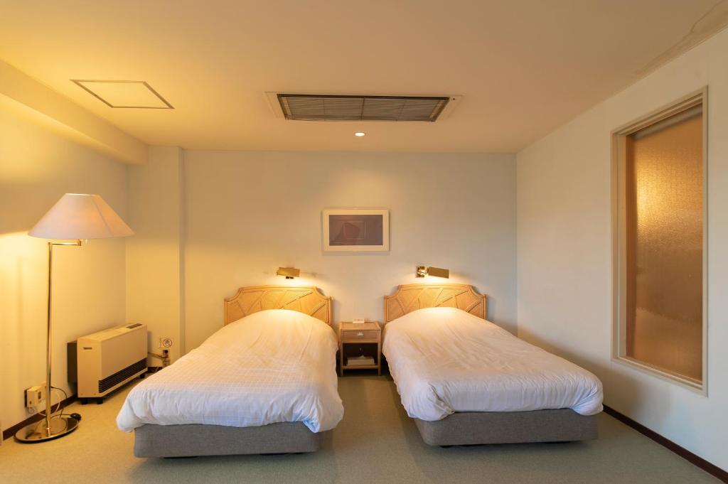 Postel nebo postele na pokoji v ubytování Fuji Premium Resort