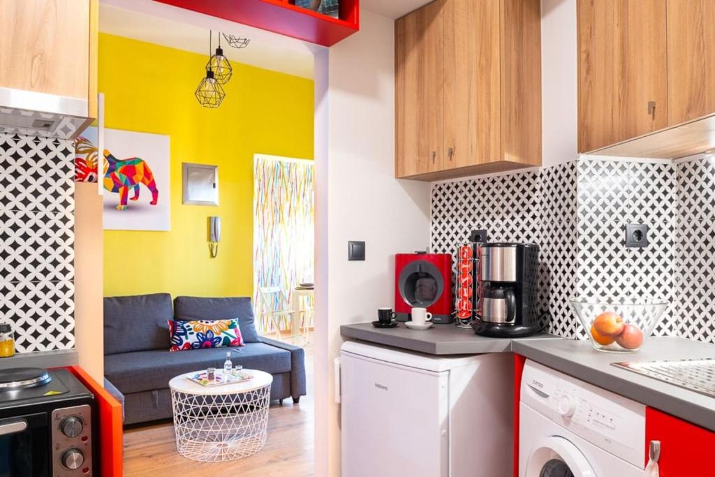 a kitchen with a washer and dryer in a room at Deco city center apartment in Heraklio