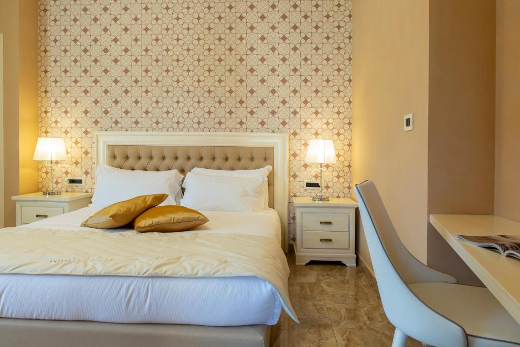 Postel nebo postele na pokoji v ubytování Aurum Suites