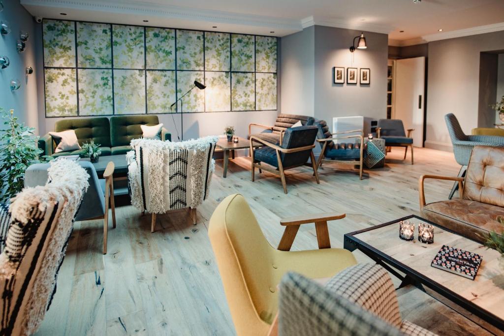 a living room with couches and chairs at The Bonnie Badger in Gullane