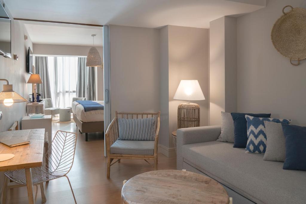 a living room with a couch and a table at Vincci Puertochico in Santander