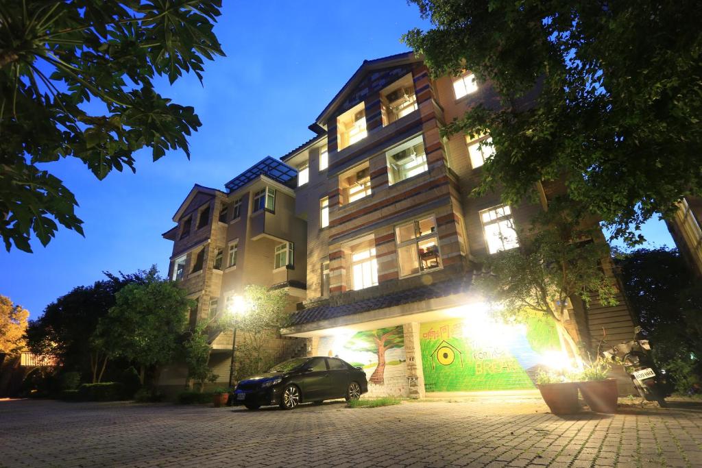 a car parked in front of a building at night at 响銅鑼民宿 in Tongluo