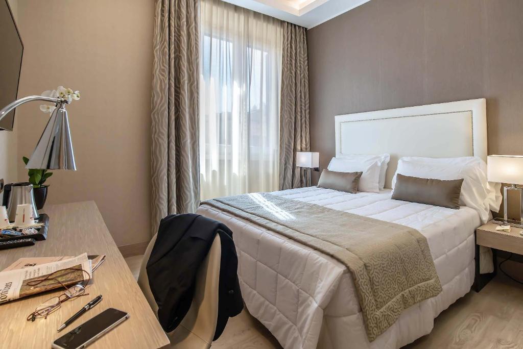 Postel nebo postele na pokoji v ubytování Hotel Genova