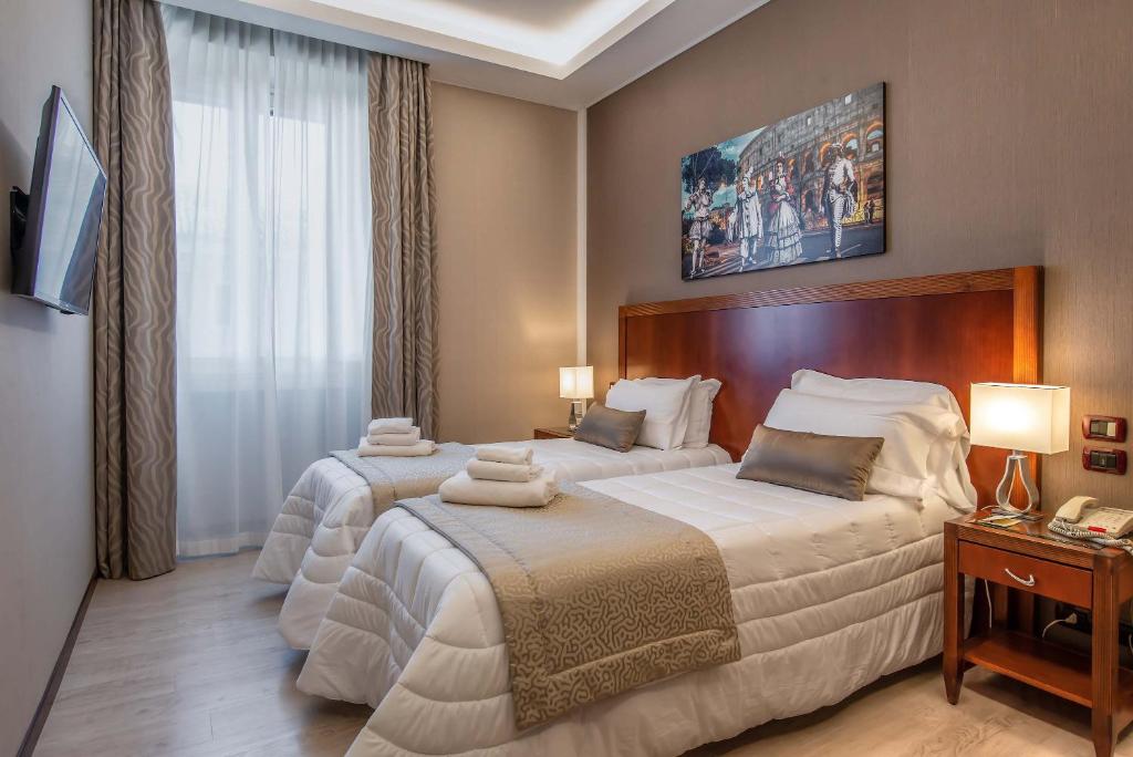 Postel nebo postele na pokoji v ubytování Hotel Genova
