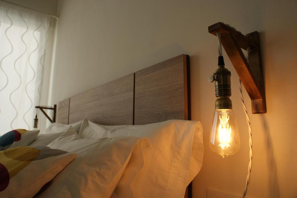 a bedroom with a bed with a light on the wall at Loft Cádiz in Cádiz