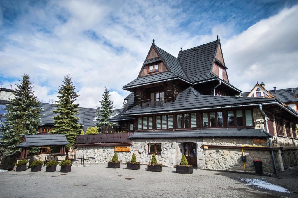 a large house with a gambrel roof at Pensjonat Jastrzębia Turnia in Zakopane