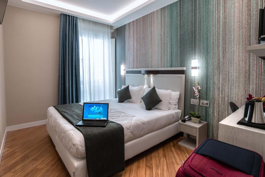 Postel nebo postele na pokoji v ubytování Hotel Memphis