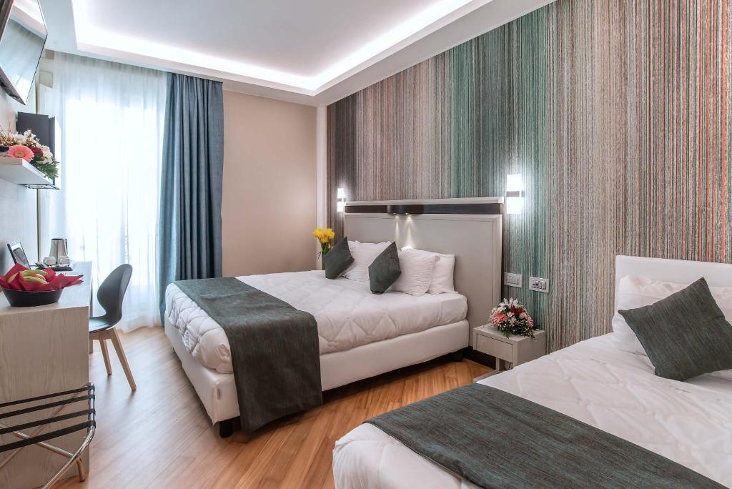 Postel nebo postele na pokoji v ubytování Hotel Memphis
