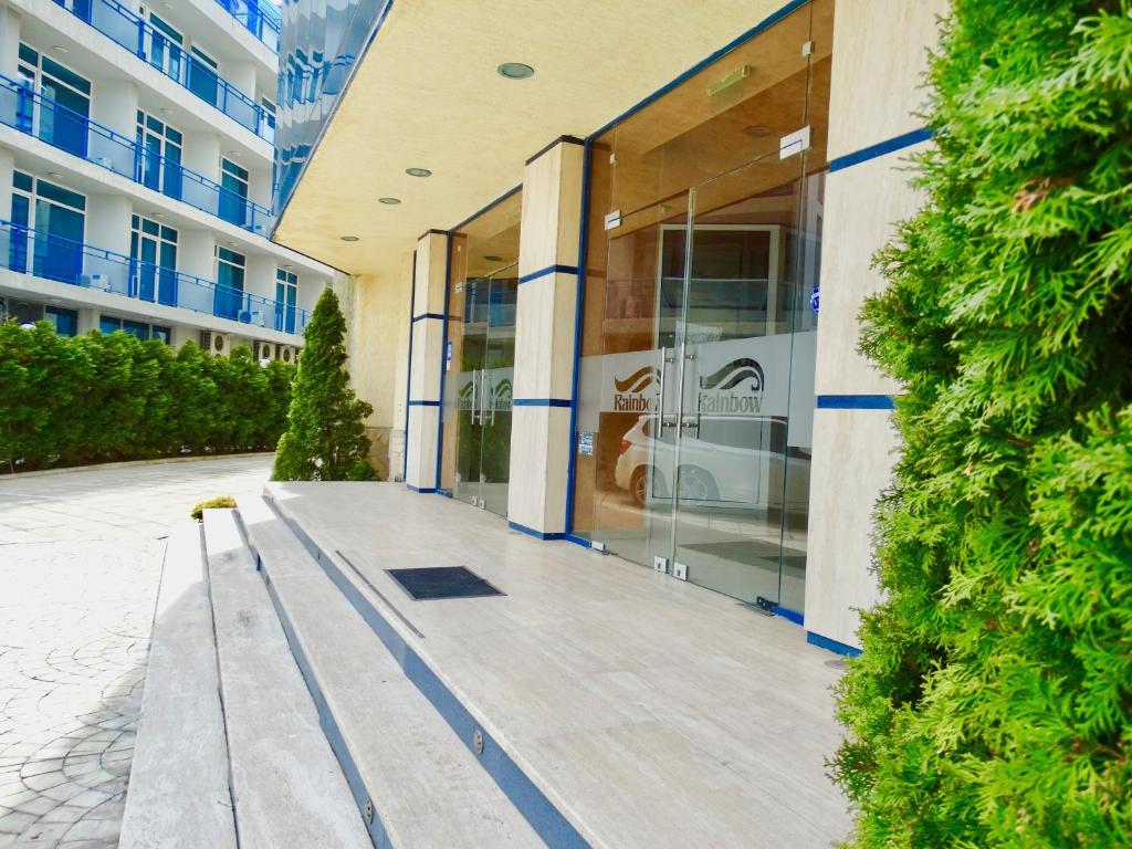 a building with a bench in front of a building at Rainbow 1 Holiday Complex in Sunny Beach