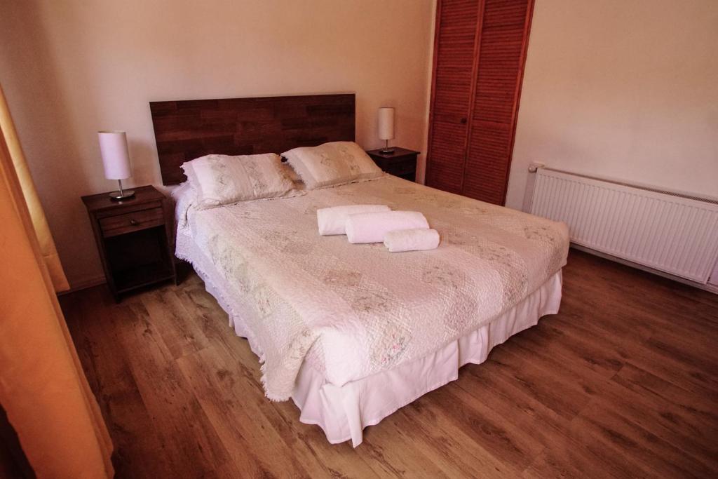 a bedroom with a bed with two towels on it at Quinta Adela Bed & Breakfast in San Pedro de Atacama