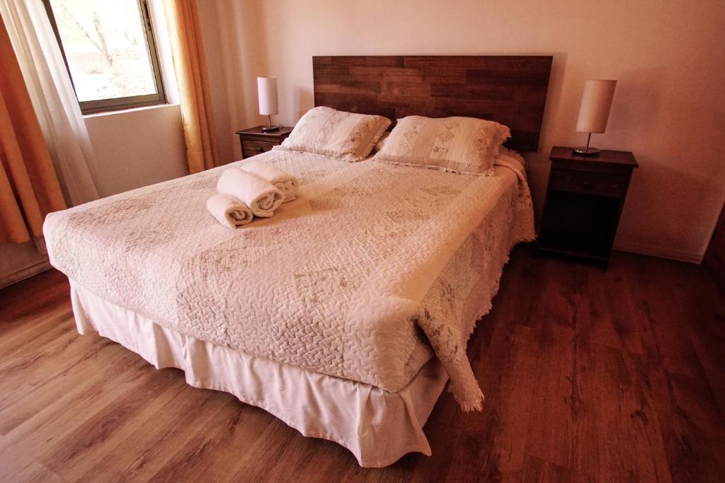 a bedroom with a bed with towels on it at Quinta Adela Bed & Breakfast in San Pedro de Atacama