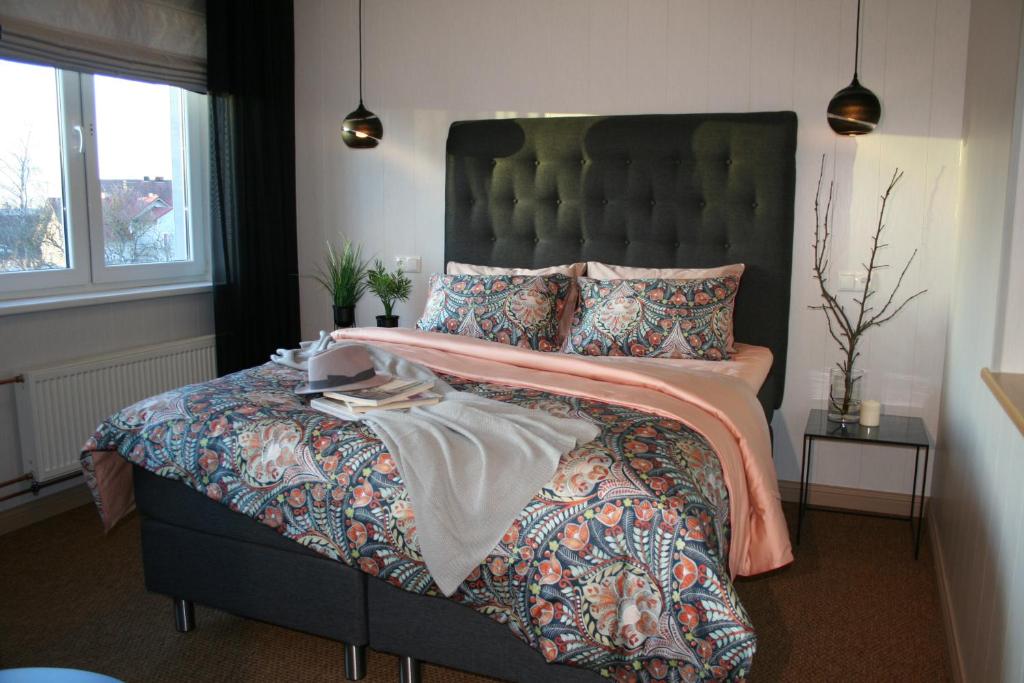 a bedroom with a large bed with a green headboard at Sadama street Villa in Pärnu