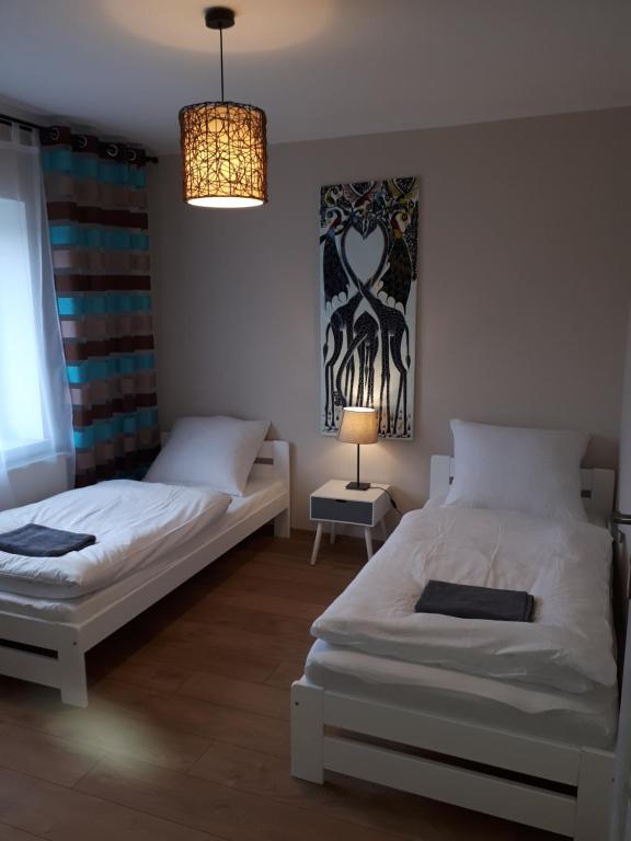 Postel nebo postele na pokoji v ubytování Apartamenty pod Dzikowcem