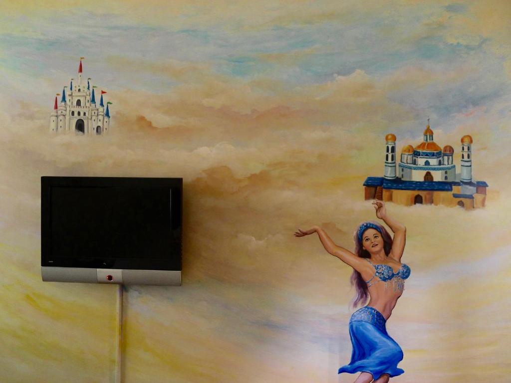 a mural of a woman with a castle on a wall at Amicasa Guesthouse in Hualien City