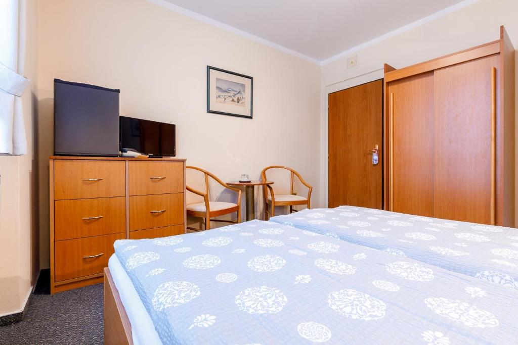 Łóżko lub łóżka w pokoju w obiekcie Hotel Jitřenka