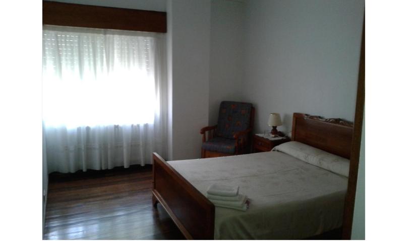 A bed or beds in a room at Hostal Pumar