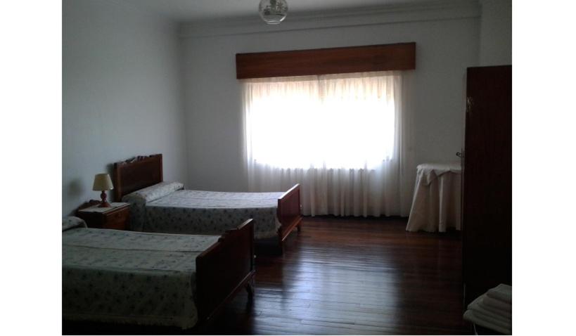 A bed or beds in a room at Hostal Pumar