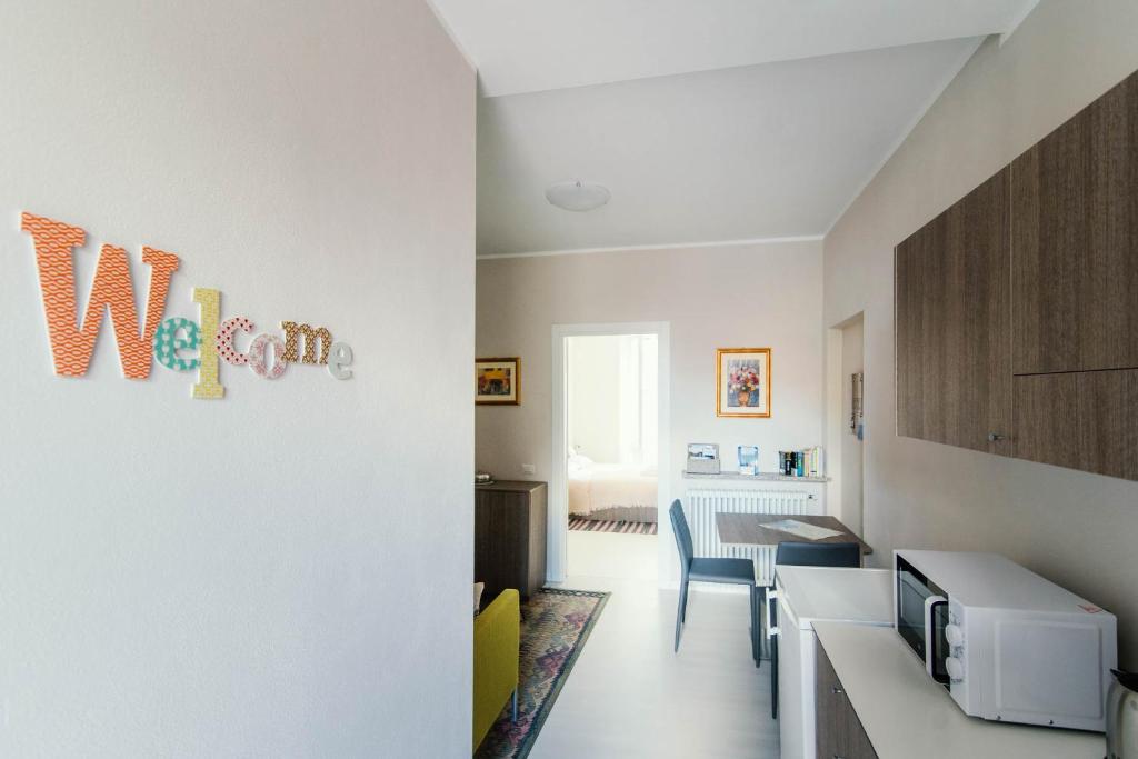 a room with a kitchen with a counter and chairs at La Corte dei Balconi 1 in Como