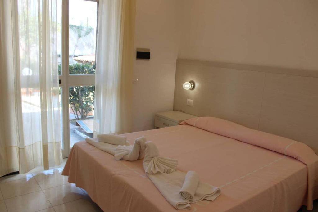 Postel nebo postele na pokoji v ubytování Hotel Al Bosco