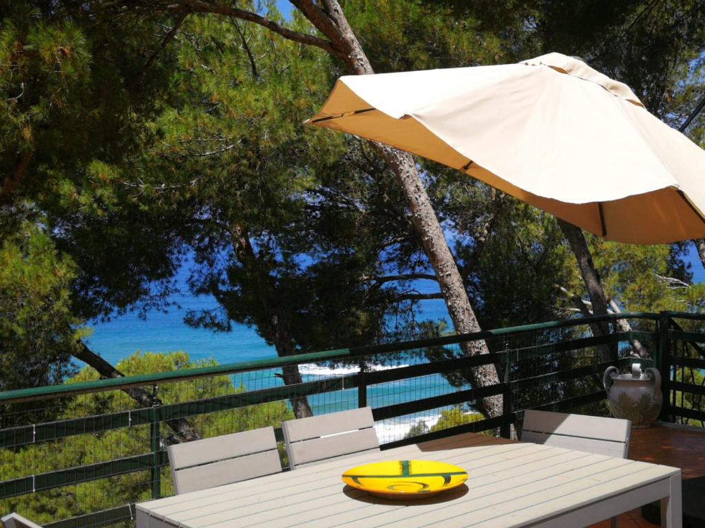 a yellow lifebuoy sitting on a table with an umbrella at Casa Mia Casa di Charme in Santa Maria di Castellabate