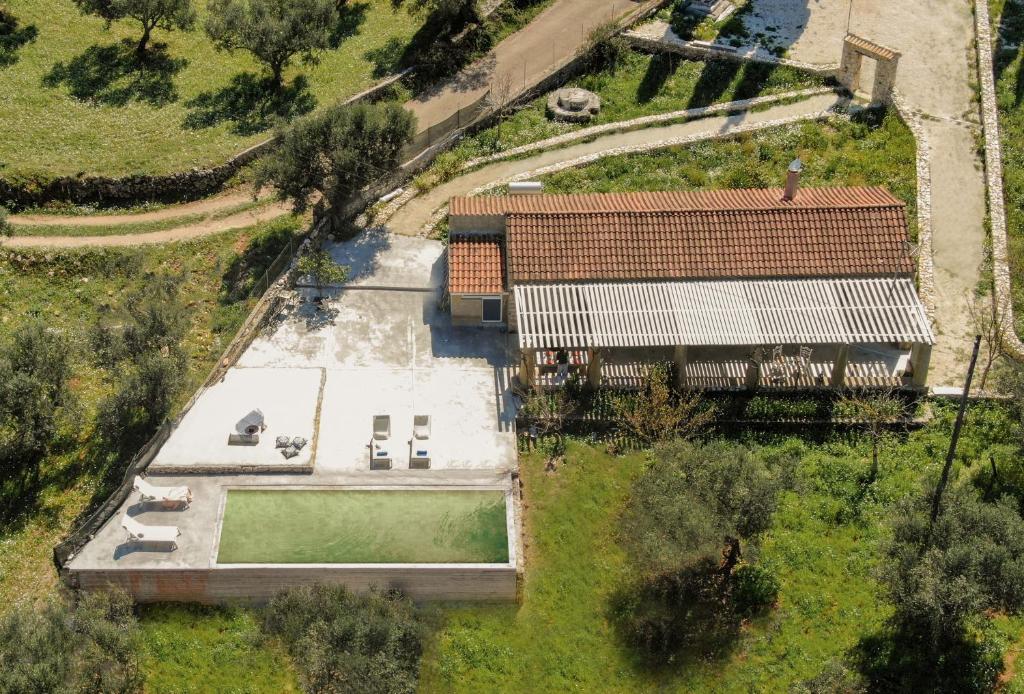 an overhead view of a house with a swimming pool at Ag Thekla Est 1924 in Skinária