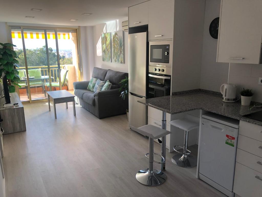 uma cozinha e sala de estar com um sofá e uma mesa em La Moderna Apartament em Salou
