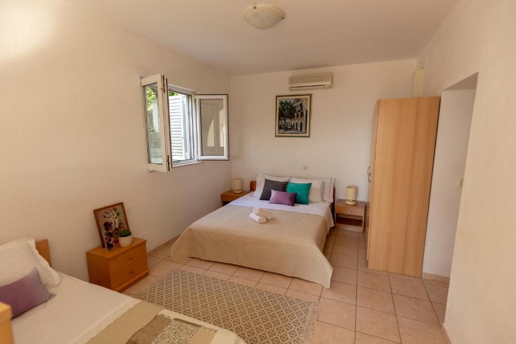 Postel nebo postele na pokoji v ubytování Apartmani Maja