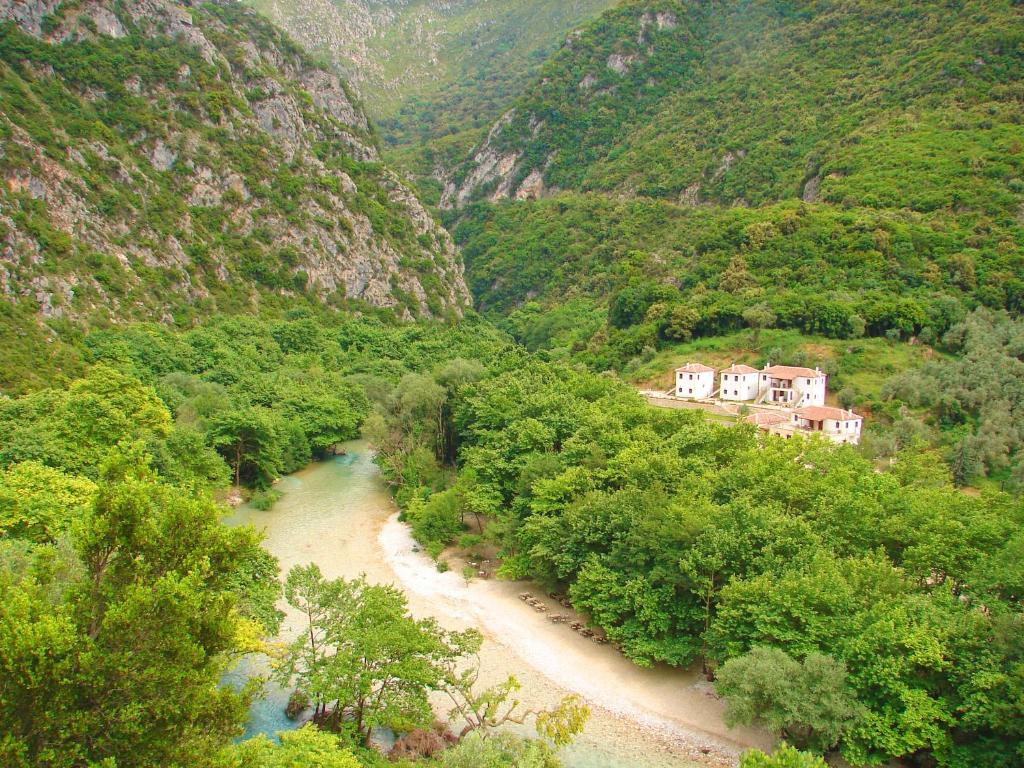 a view of a river in a valley with houses at Piges Hotel in Gliki