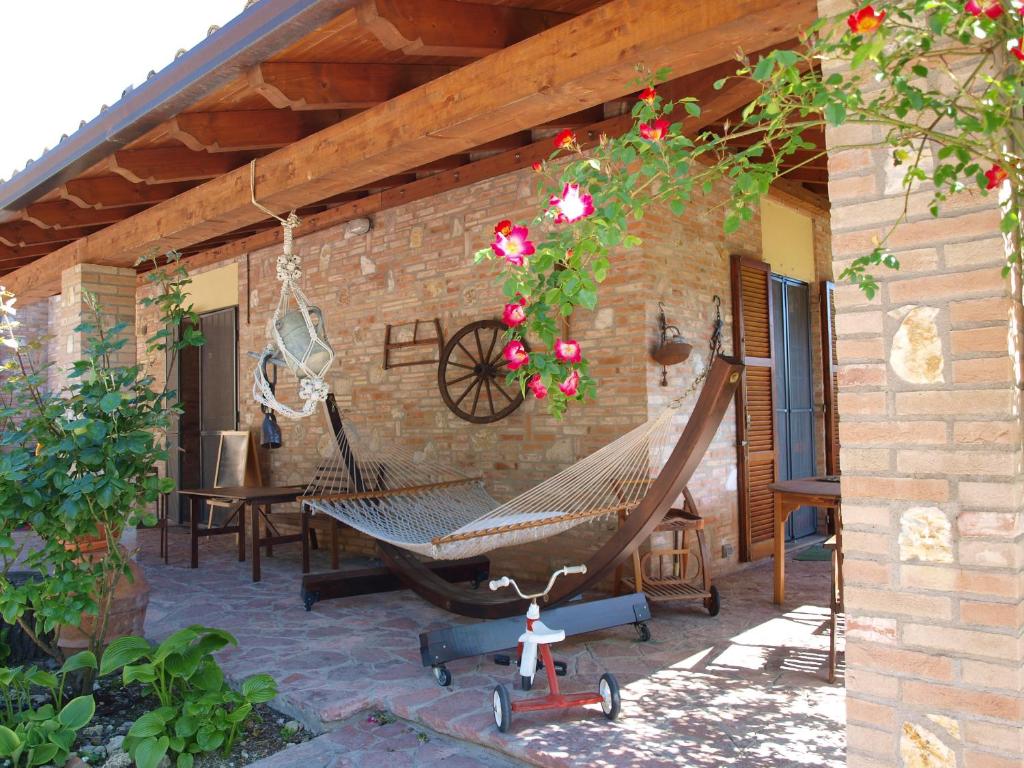 a patio with a hammock on the side of a house at C'era Una Volta B&B in Perugia