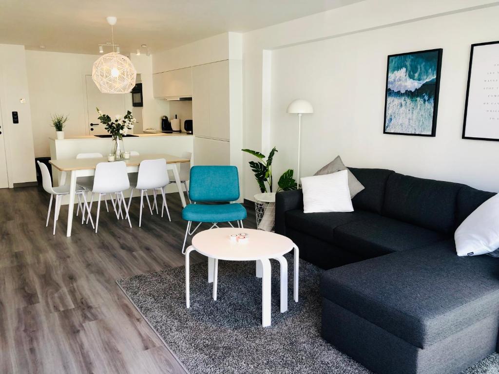 a living room with a couch and a table at New Port apartment in Nieuwpoort