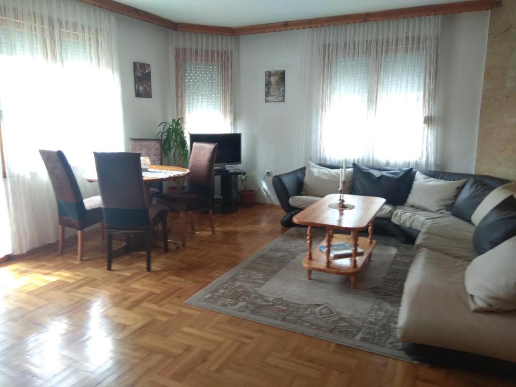 a living room with a couch and a table at Martin`s apartments in Stara Zagora