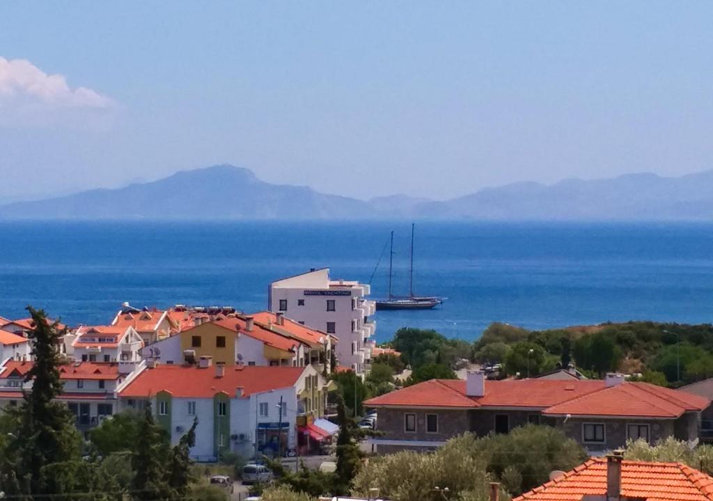 a view of a town with a boat in the water at Ertem Apart in Datca