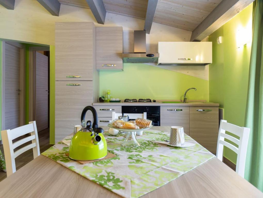 a kitchen with a table with a yellow tea pot on it at Il Sopracciglio Suites - Green Suite in Cassino