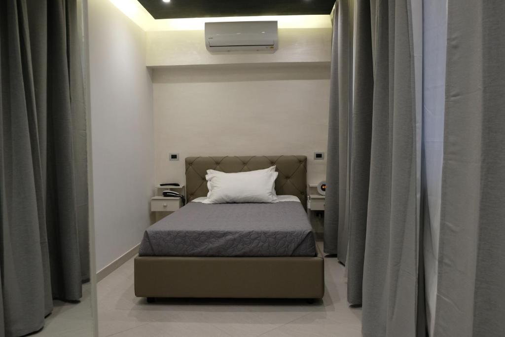 Postel nebo postele na pokoji v ubytování B&B Rossini Luxury
