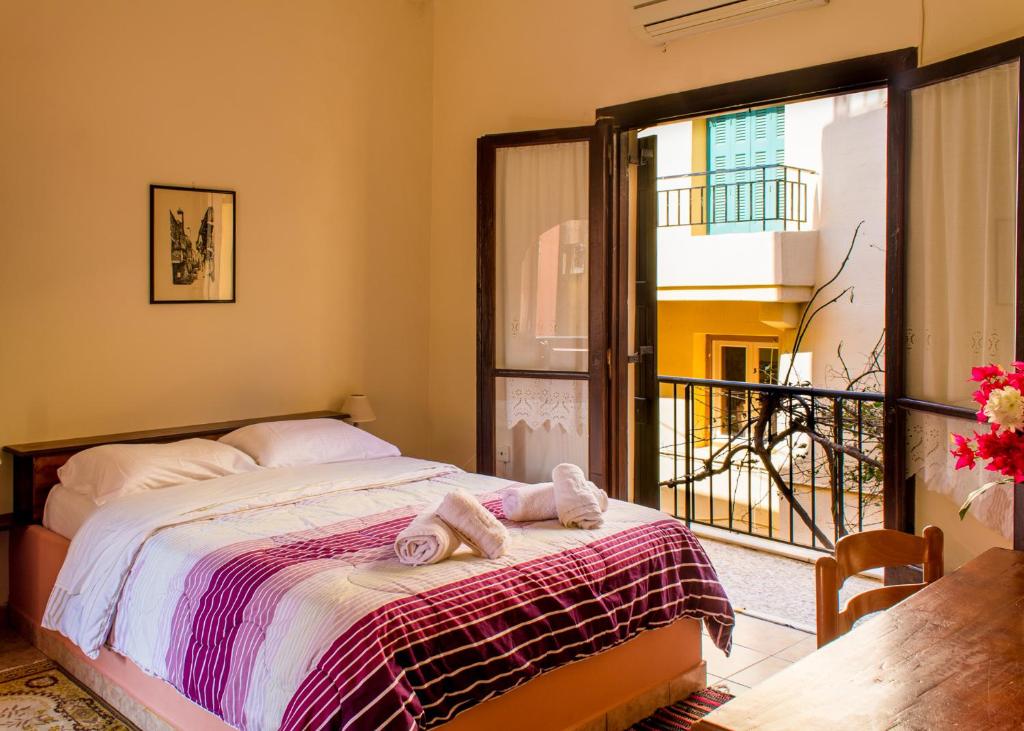 a bedroom with a bed and a large window at Iason Studios in Chania Town