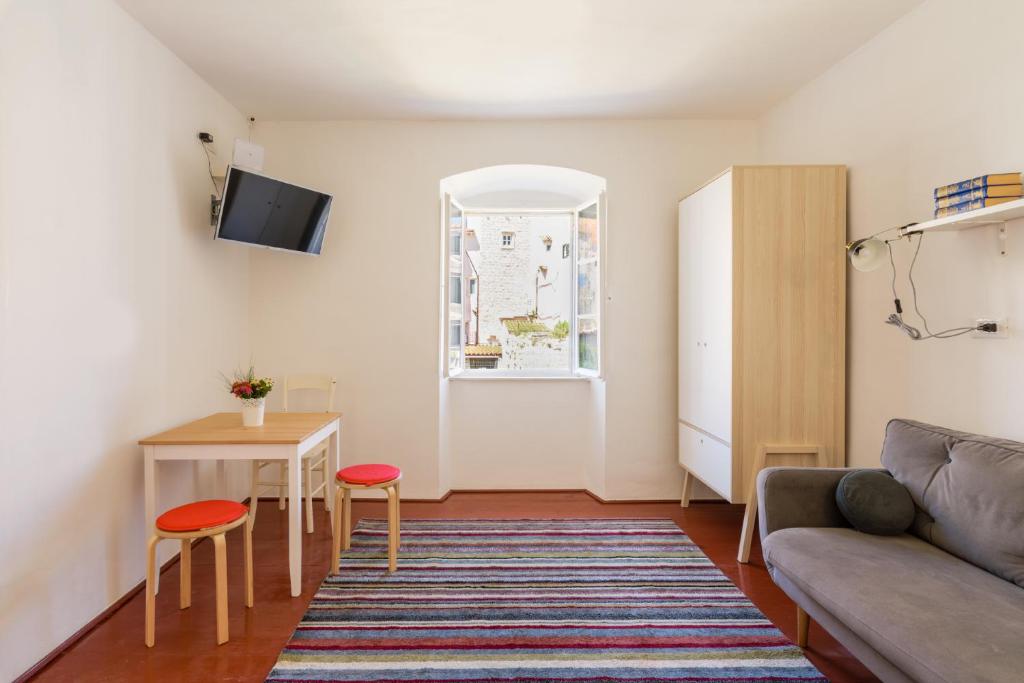 a living room with a couch and a table at Apartments Aerial in Dubrovnik