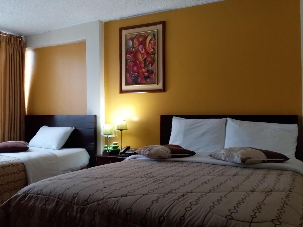 Postel nebo postele na pokoji v ubytování Hostal El Roble