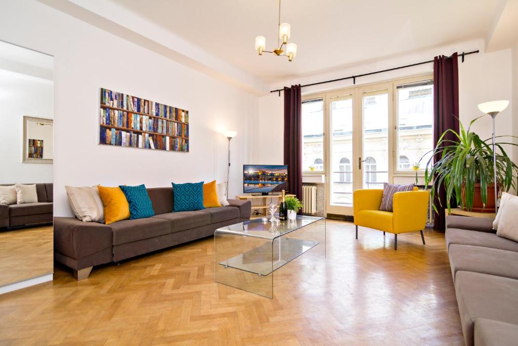 a living room with a couch and a table at Apartments with 2 Bathrooms in Prague