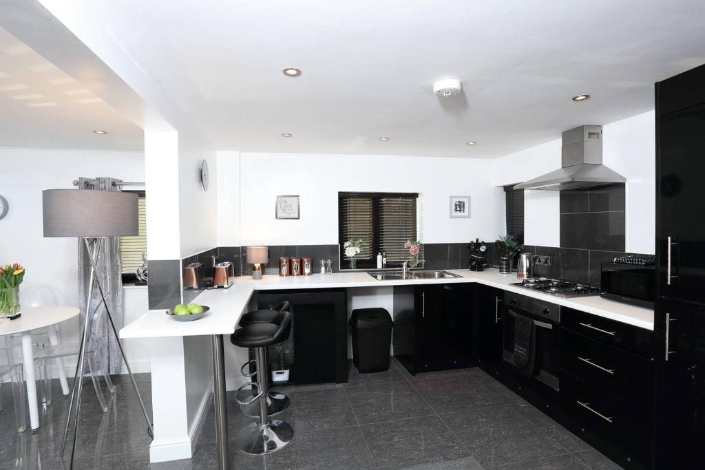 a kitchen with black cabinets and a white counter top at 8 Park Terrace in Southwell