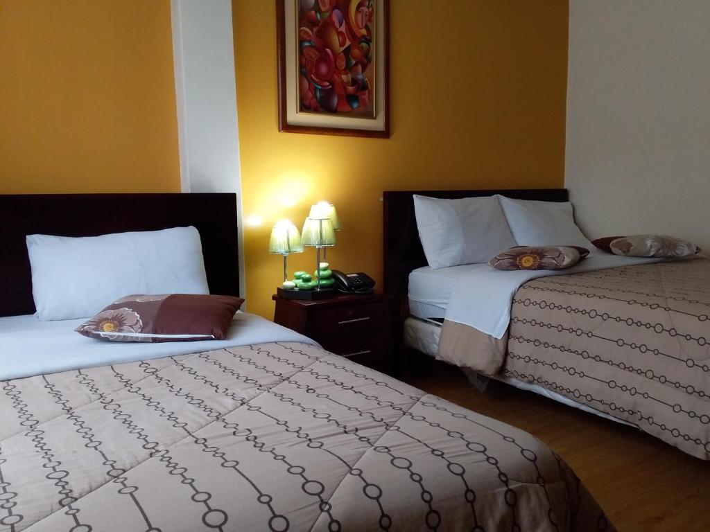 Postel nebo postele na pokoji v ubytování Hostal El Roble