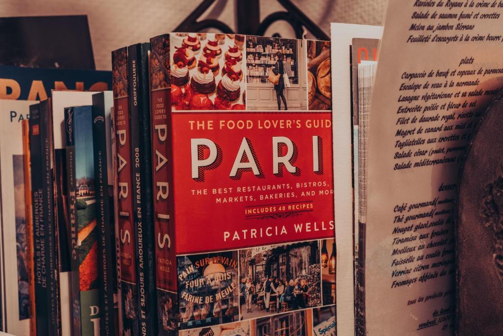 a pile of books on a shelf at New Orient Hotel in Paris