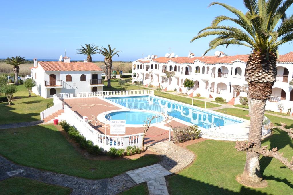 an aerial view of a house with a swimming pool and a palm tree at Girasols Garden 3 in Son Bou