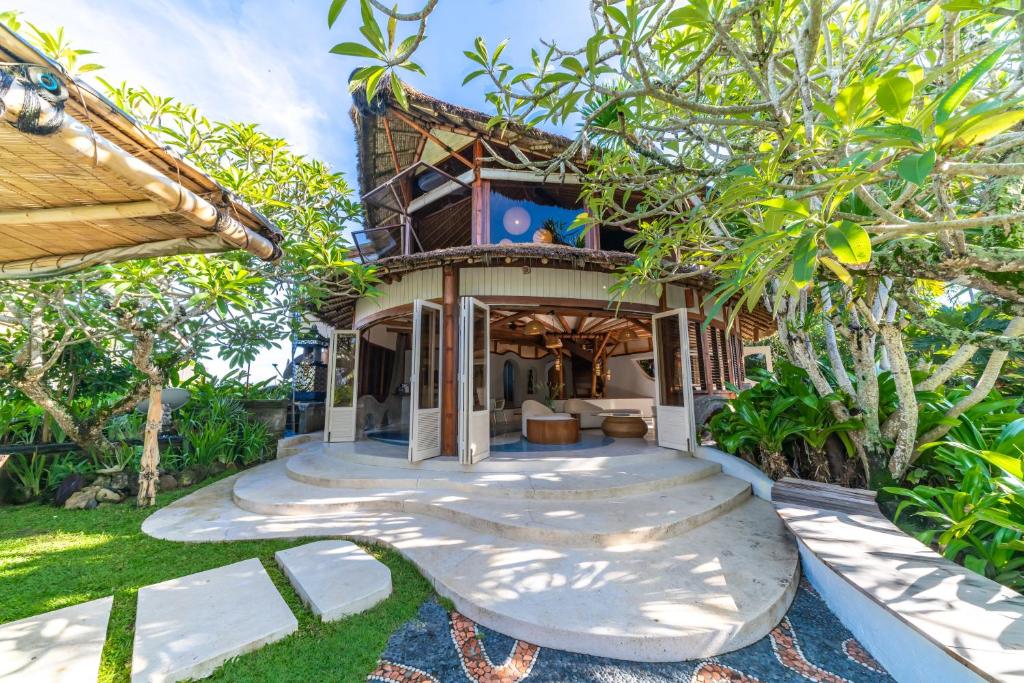 a house with a pathway leading to the front of it at Sejuk Beach Villas in Canggu