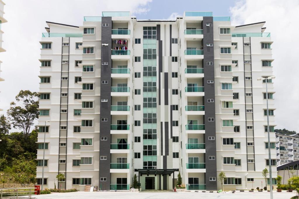 a large white building with many windows at Quintet Serviced Apartment @ Cameron in Cameron Highlands