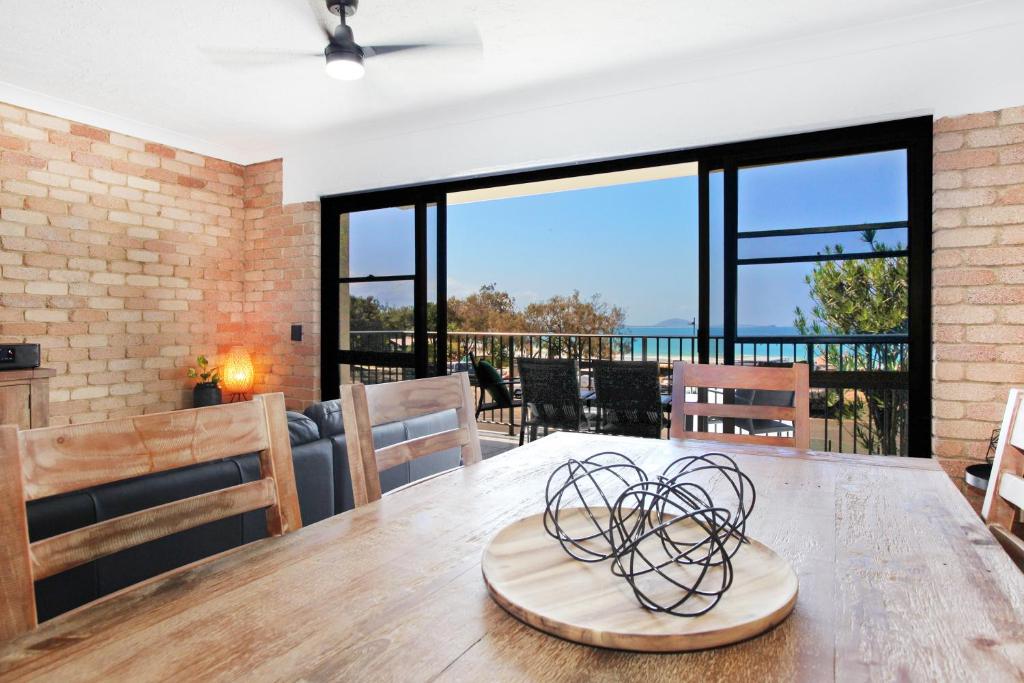 a dining room table with a view of the ocean at Illawong Apartment 7 in Mooloolaba