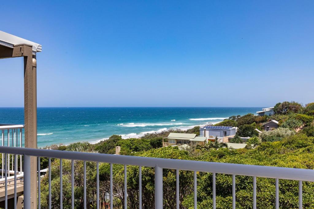 a view of the ocean from the balcony of a house at Wake up to ocean views in stylish comfort in Sunshine Beach