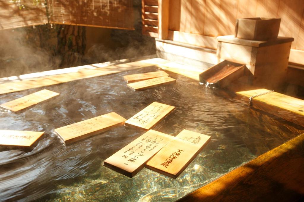 a pool of water with signs on the floor at Gingetsu in Shimo-suwa