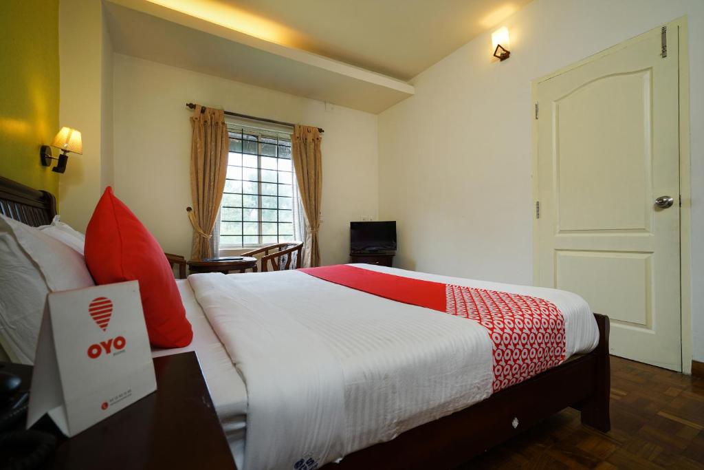 Postel nebo postele na pokoji v ubytování MGS Residency