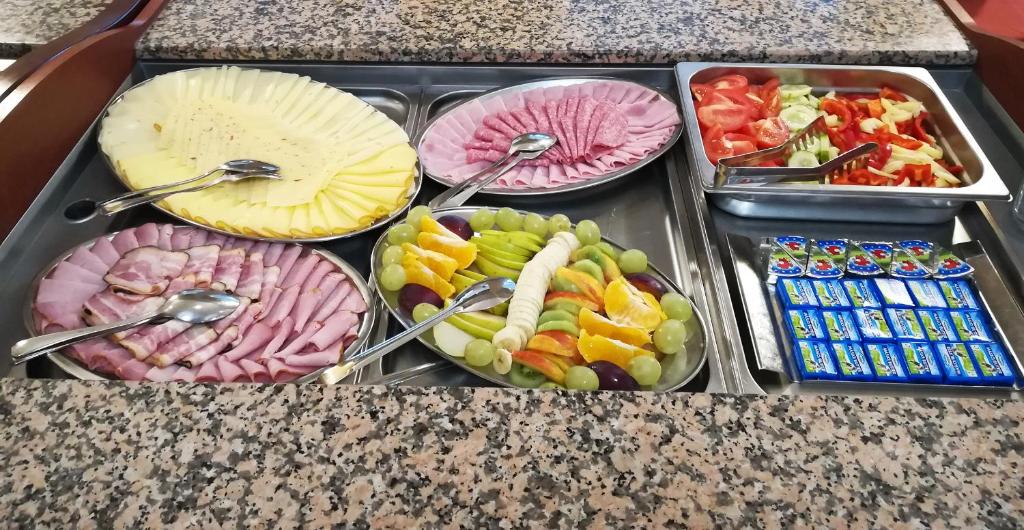 a tray filled with different types of food on a counter at Hotel Toč in Lipova Lazne